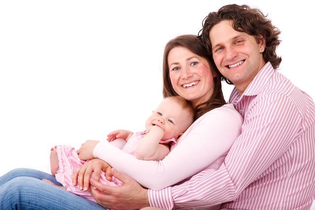 Una pareja con su niña en brazos